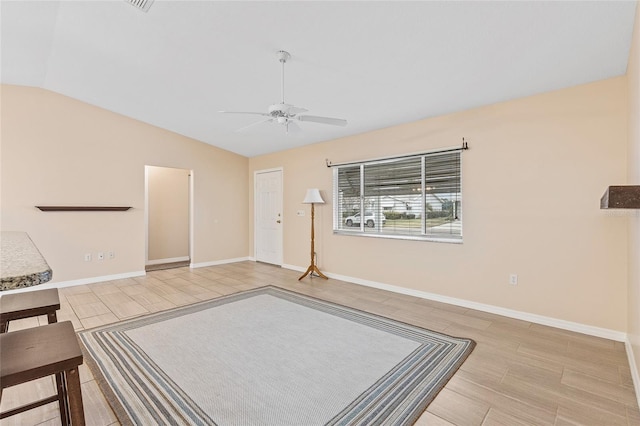 unfurnished living room featuring ceiling fan and lofted ceiling