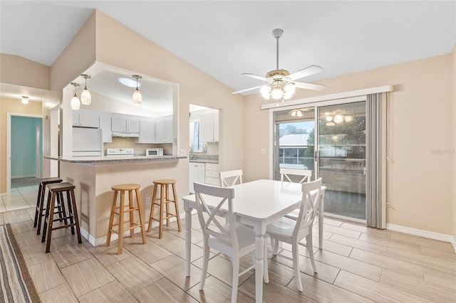 dining space featuring vaulted ceiling and ceiling fan