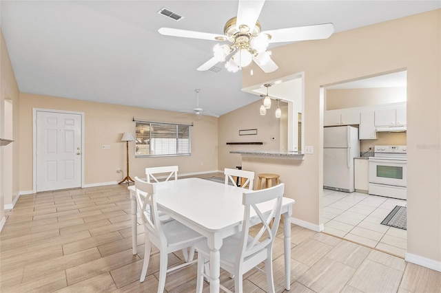 dining area featuring ceiling fan and lofted ceiling