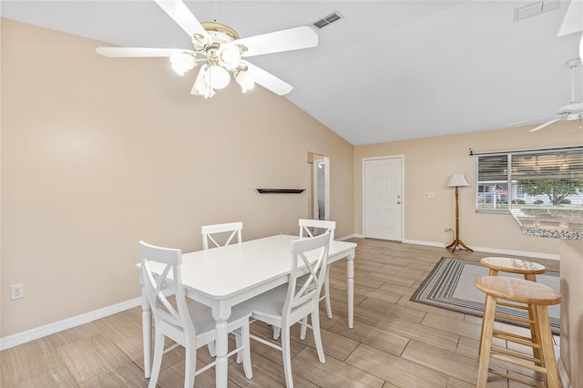 dining room with ceiling fan and vaulted ceiling