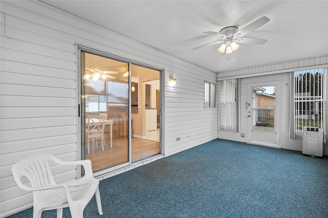 unfurnished sunroom with ceiling fan and plenty of natural light