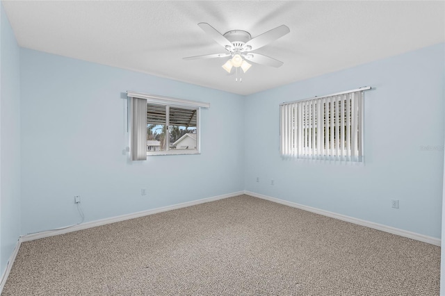 empty room with ceiling fan, carpet, and a healthy amount of sunlight