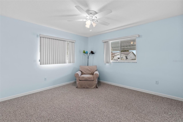 unfurnished room with ceiling fan and carpet