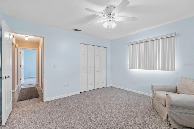 unfurnished room with ceiling fan and carpet floors