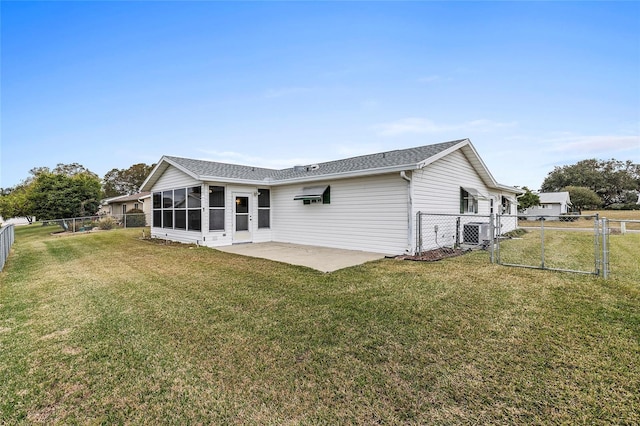 back of property with a yard, central AC, and a patio area