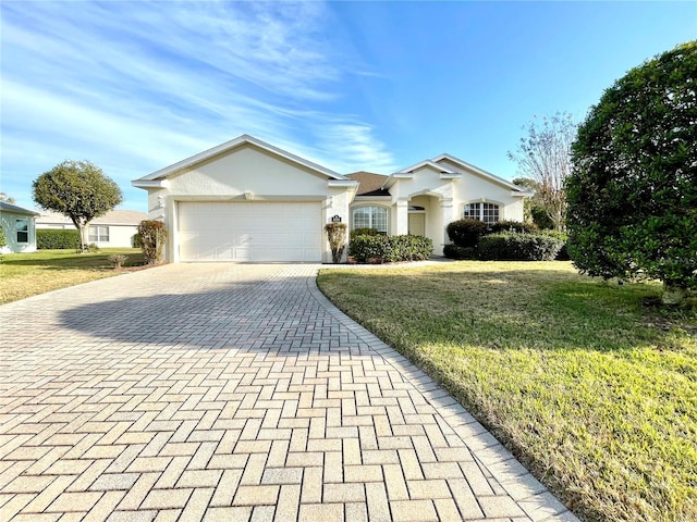 single story home featuring a front yard and a garage