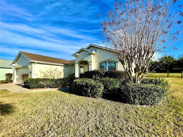 view of front of house with a front yard and a garage