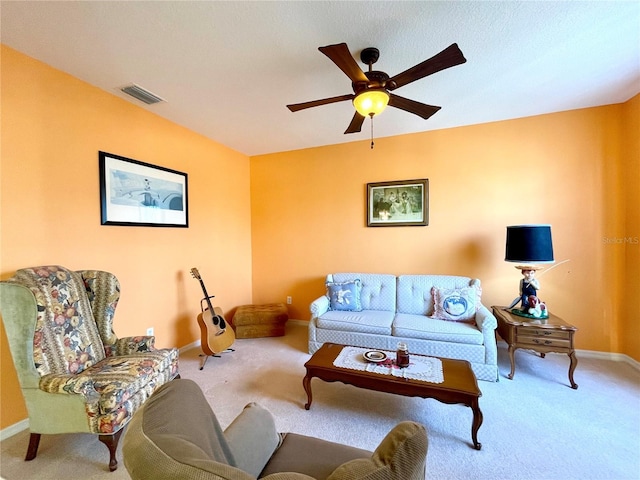 carpeted living room featuring ceiling fan