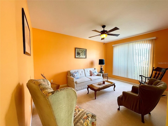 living room with ceiling fan and light colored carpet