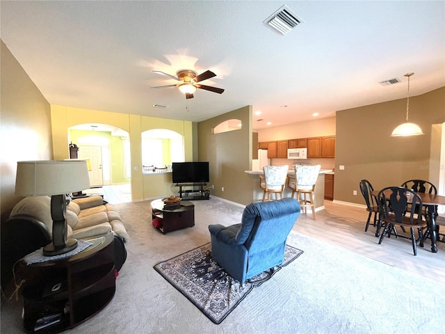 living room featuring ceiling fan and light carpet