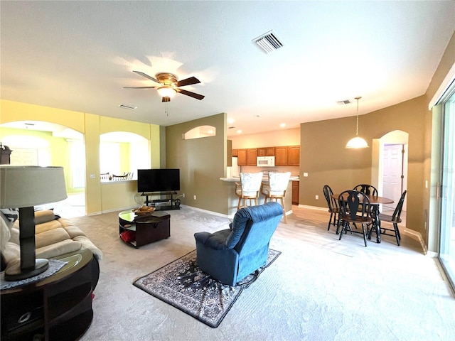 carpeted living room featuring ceiling fan