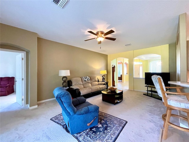 carpeted living room featuring ceiling fan