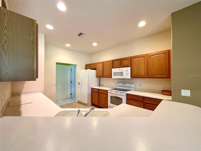 kitchen featuring white appliances and sink