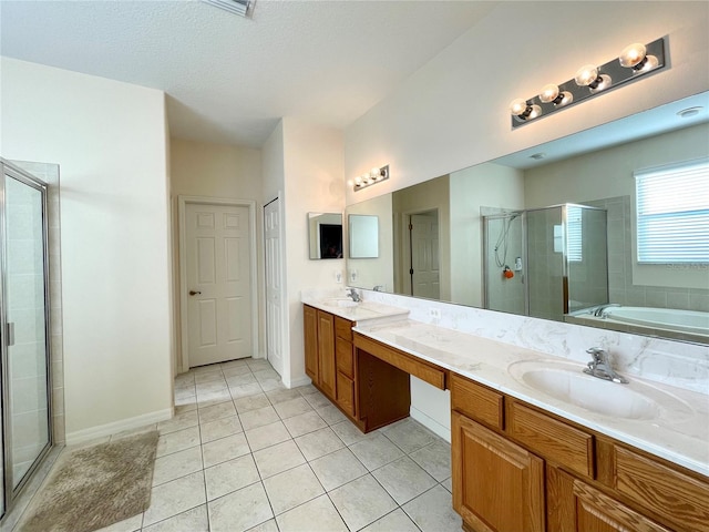 bathroom featuring plus walk in shower, a textured ceiling, vanity, and tile patterned floors