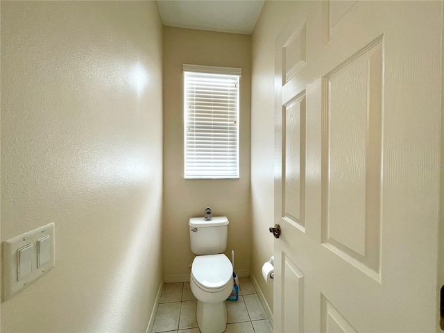 bathroom with tile patterned floors and toilet