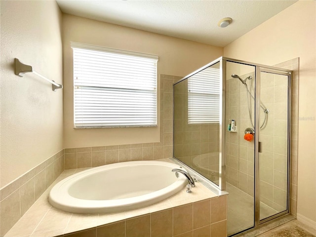 bathroom featuring separate shower and tub