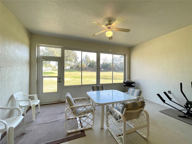 sunroom / solarium featuring ceiling fan