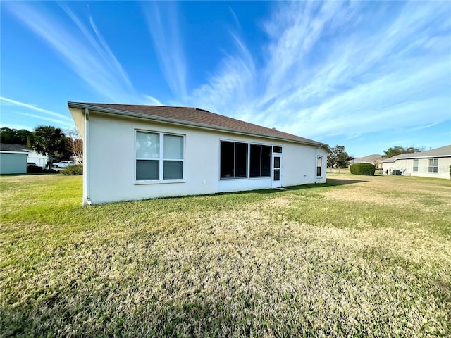 rear view of house with a lawn