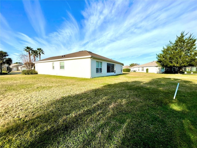 view of side of home featuring a yard