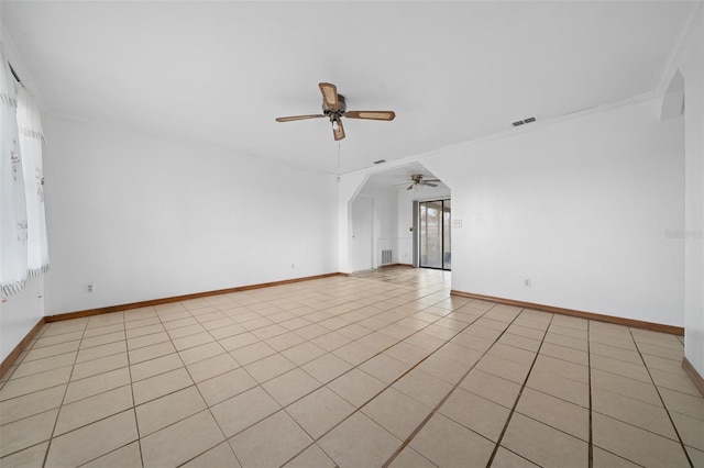 tiled empty room featuring crown molding and ceiling fan