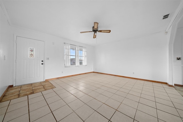 tiled entrance foyer featuring ceiling fan and ornamental molding