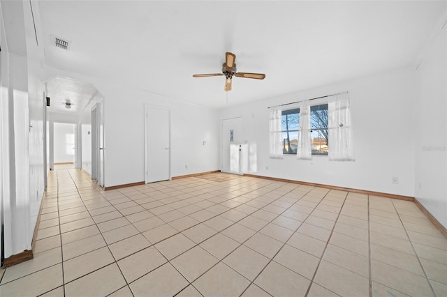 tiled empty room featuring ceiling fan