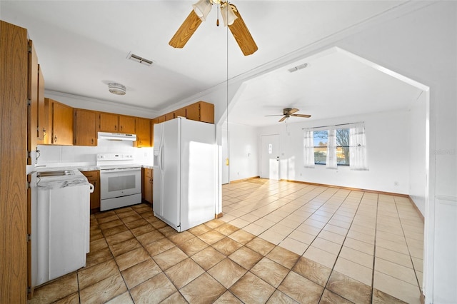 kitchen with white appliances, crown molding, sink, ceiling fan, and light tile patterned floors