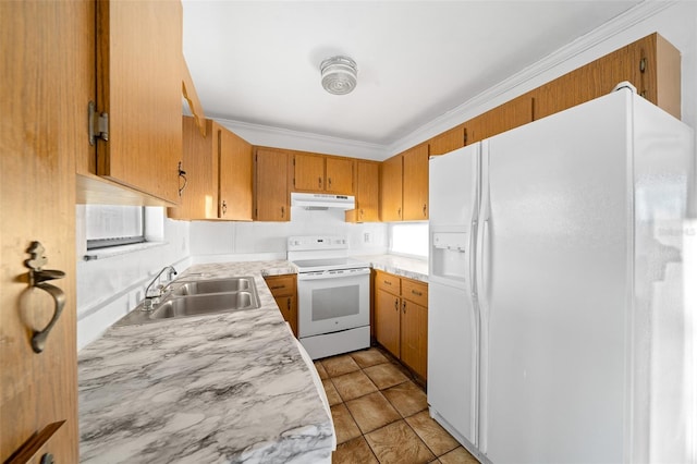 kitchen with light tile patterned floors, white appliances, sink, and a wealth of natural light