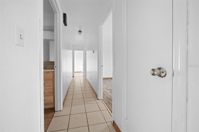 hall with light tile patterned floors