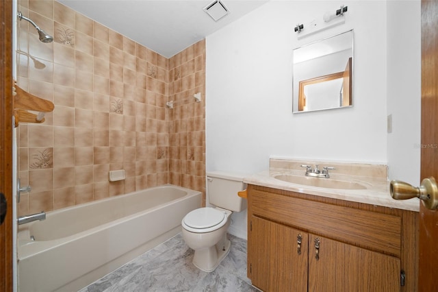 full bathroom featuring toilet, vanity, and tiled shower / bath