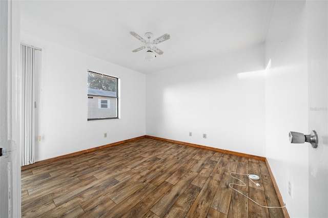 spare room featuring ceiling fan and dark wood-type flooring