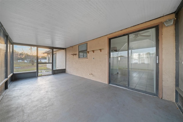 unfurnished sunroom featuring ceiling fan