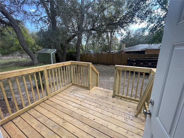 383 S Rooks Ave, Inverness, FL 34453 - wooden terrace featuring an outbuilding, a fenced backyard, and a shed