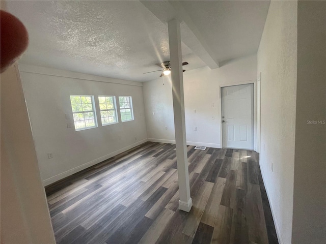 383 S Rooks Ave, Inverness, FL 34453 - unfurnished bedroom with a ceiling fan, dark wood-style floors, baseboards, and a textured ceiling