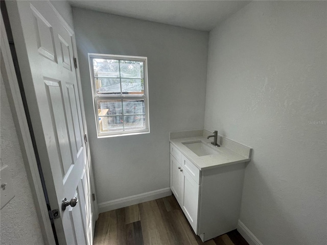 383 S Rooks Ave, Inverness, FL 34453 - laundry area featuring dark wood-style floors, baseboards, and a sink