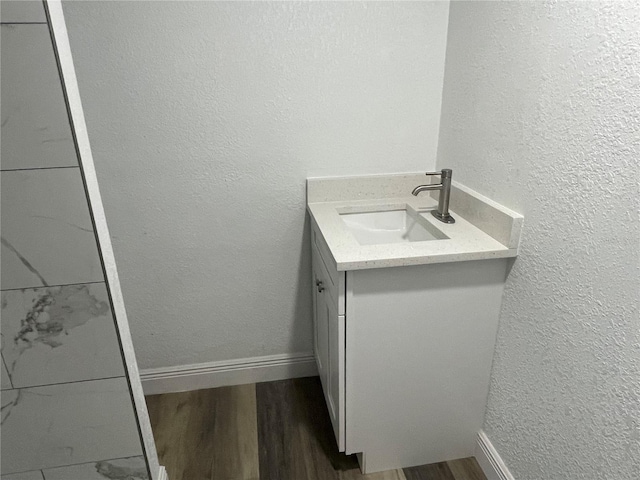 383 S Rooks Ave, Inverness, FL 34453 - bathroom featuring baseboards, wood finished floors, vanity, and a textured wall