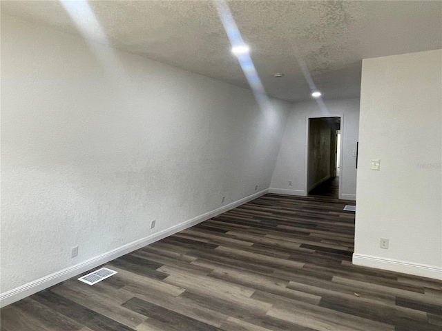 383 S Rooks Ave, Inverness, FL 34453 - unfurnished room featuring dark wood-style floors, visible vents, baseboards, recessed lighting, and a textured ceiling