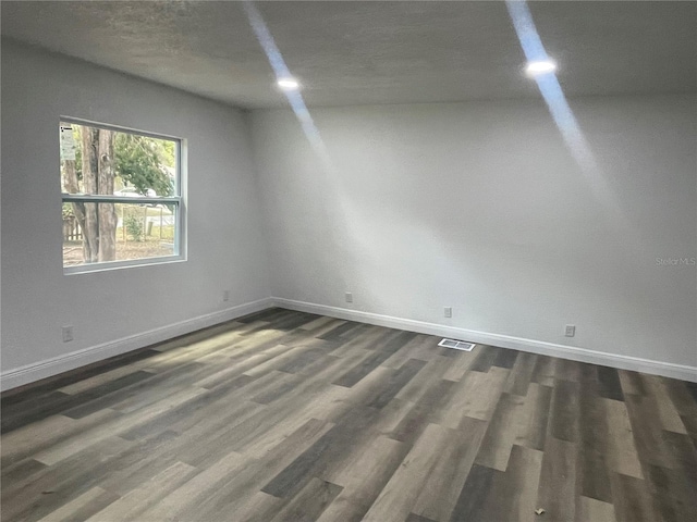383 S Rooks Ave, Inverness, FL 34453 - empty room with dark wood-style floors, visible vents, and baseboards