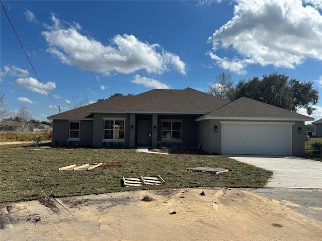 view of front of property with a garage and a front yard