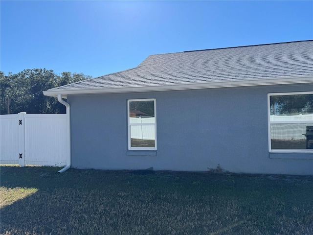 view of side of home with a yard