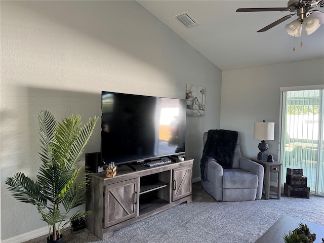 carpeted living room with ceiling fan and lofted ceiling