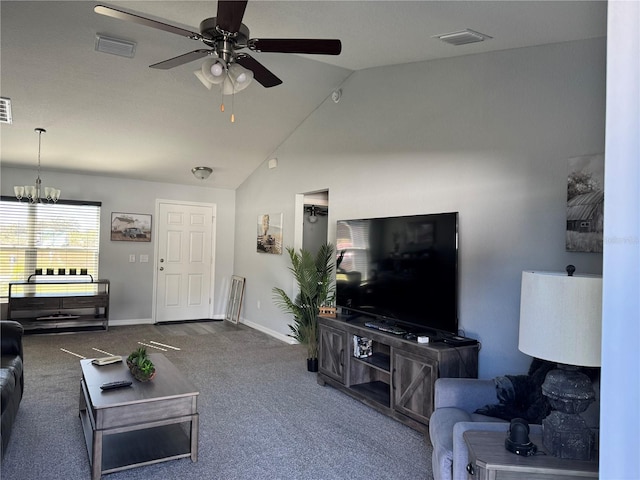 living room featuring ceiling fan with notable chandelier, carpet floors, and vaulted ceiling