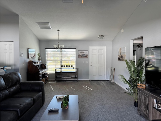 living room with an inviting chandelier, dark carpet, and lofted ceiling