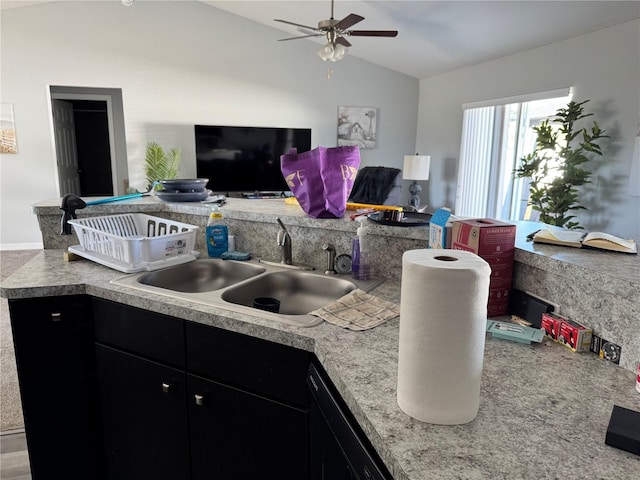 kitchen with ceiling fan, sink, and vaulted ceiling