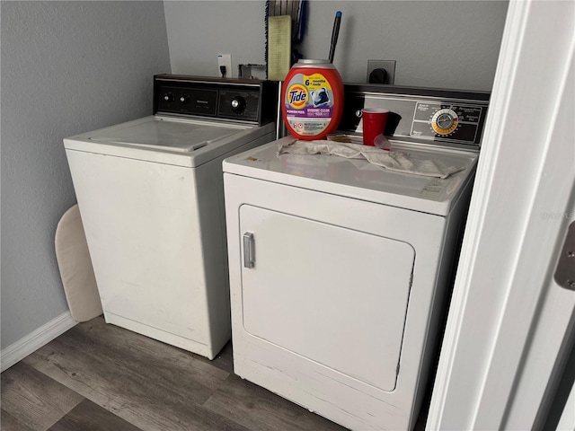 washroom with washer and clothes dryer and dark hardwood / wood-style flooring