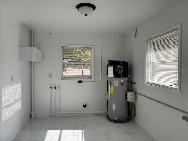 utility room featuring hybrid water heater