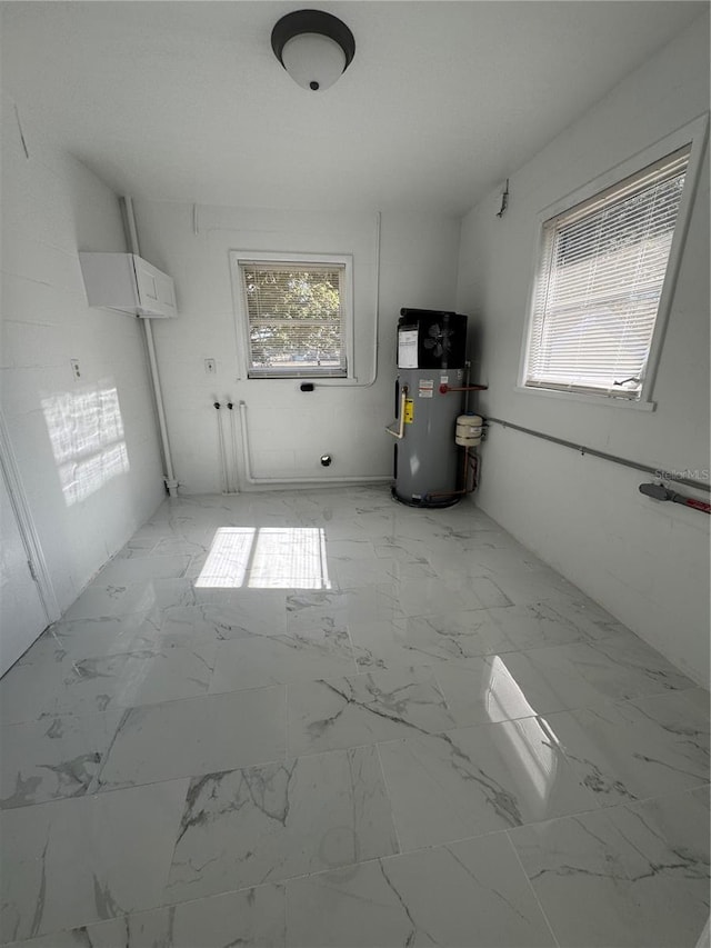 kitchen with marble finish floor and heat pump water heater