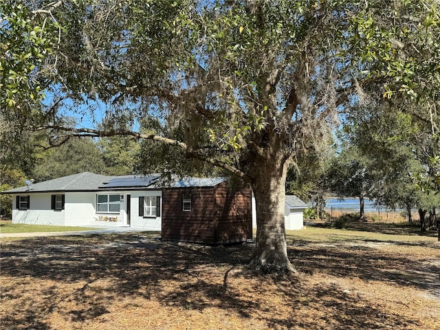 view of property exterior with solar panels