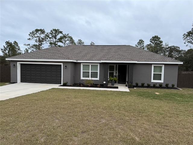 single story home featuring a garage and a front lawn