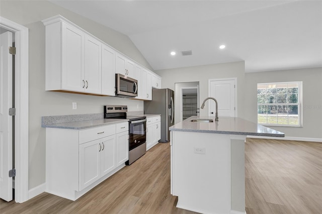 kitchen featuring white cabinetry, sink, an island with sink, and stainless steel appliances